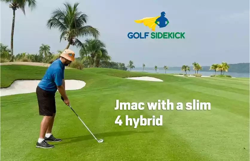jmac hitting a hybrid golf club